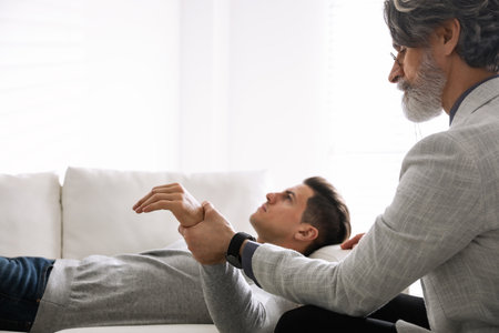 Psychotherapist and patient in office. Hypnotherapy sessionsの写真素材