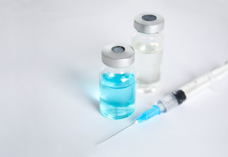 Vials and syringe on light background. Vaccination and immunizationの写真素材