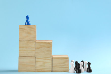 Block staircase and color game pieces on light blue background, space for text. career promotion conceptの写真素材