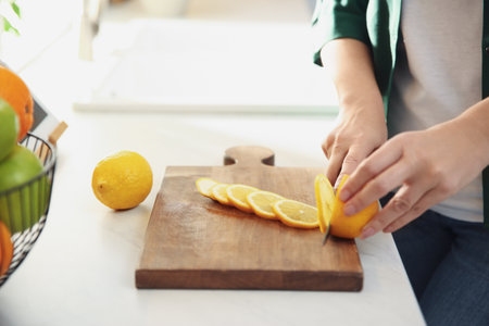 Woman cooking at table in kitchen, closeupの写真素材