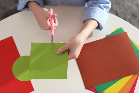 Little girl making greeting card at table indoors, top view. creative hobbyの写真素材