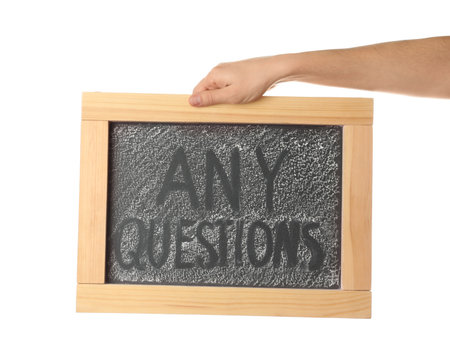 Woman holding blackboard with phrase ANY QUESTIONS on white background, closeupの写真素材