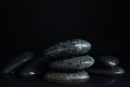 Stones in water on black background. Zen lifestyleの写真素材