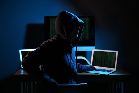 Hacker with computers in dark room. cybercrime