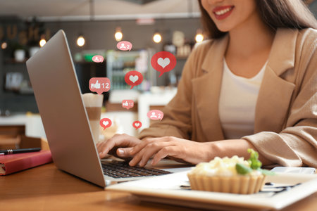 Blogger working with laptop in cafe, closeup