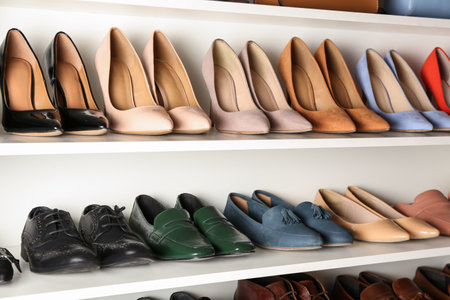 White shelving unit with different leather shoesの写真素材
