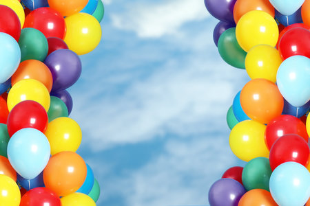 Bunch of colorful balloons outdoors on sunny dayの写真素材
