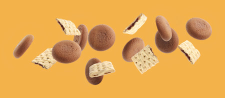 Set of different falling cookies on yellow background. banner designの写真素材