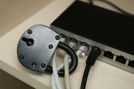 WiFi router with padlock on shelf. Protection from cyber attacks