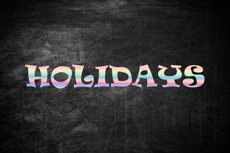 Word HOLIDAYS on black background. School's outの写真素材