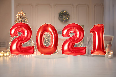Red foil 2021 balloons in festive room interiorの写真素材