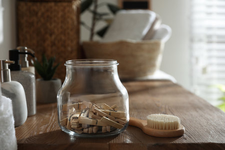 Jar with clothespins and shower brush on shelf indoors. bathroom interior elementsの写真素材
