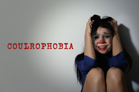 Coulrophobia concept. Double exposure of scared woman and clownの写真素材