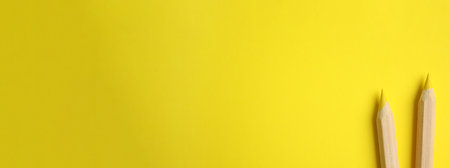 Color pencils on yellow background, flat lay with space for text. banner design