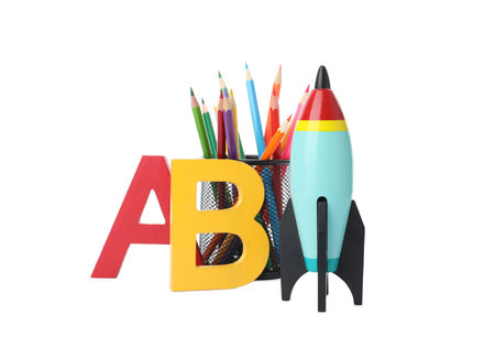 Bright toy rocket and school supplies on white backgroundの写真素材
