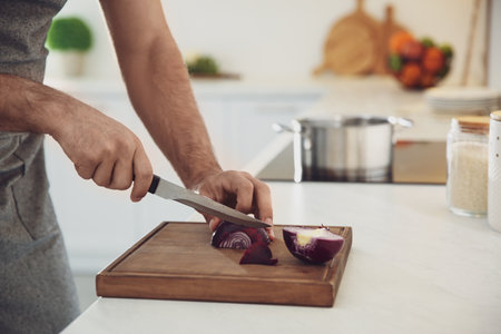 Man cooking at counter in kitchen, closeupの写真素材