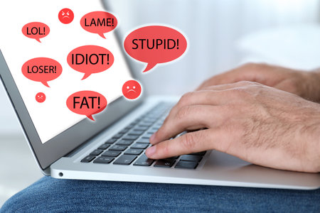 Young man using laptop, closeup. Cyber bullying