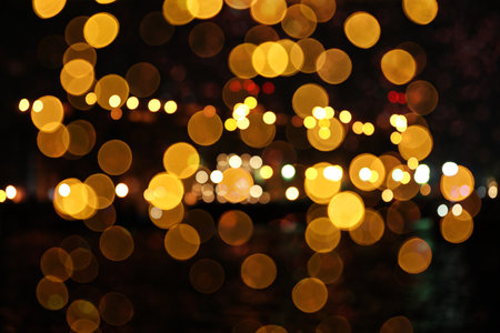 Blurred view of beautiful lights on black background. party atmosphere