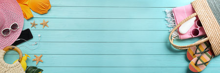 Flat lay composition with beach accessories on light blue wooden background, space for text. banner designの写真素材
