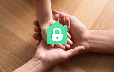 home security concept. Family holding house indoors, closeupの写真素材