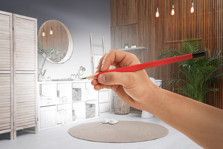 Man drawing bathroom interior design. Combination of photo and sketchの写真素材