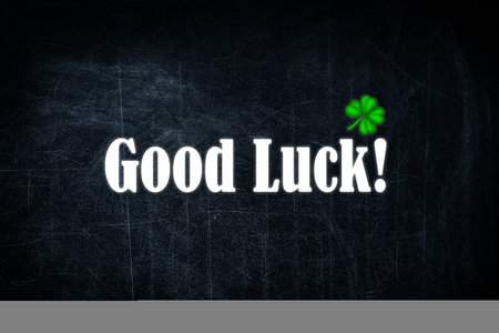 Phrase GOOD LUCK and clover leaf on black backgroundの写真素材