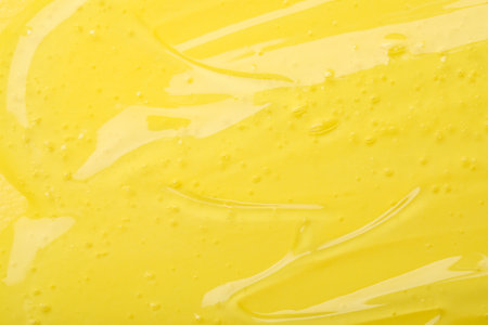 Pure transparent cosmetic gel on yellow background, closeupの写真素材