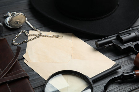 Composition with different vintage items on grey wooden table, closeup. Detective's workplace