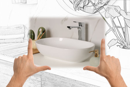 Man showing frame gesture and making bathroom real out of drawingの写真素材