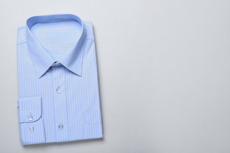 Stylish light blue shirt on white background, top view with space for text. Dry-cleaning serviceの写真素材