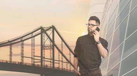 Multiple exposure of businessman with smartphone and cityscapeの写真素材