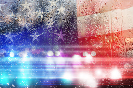 Double exposure of American flag and police cars on street at nightの写真素材