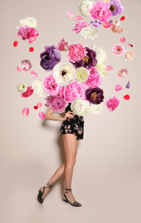 Creative spring fashion composition. Posing girl and flowers splashの写真素材