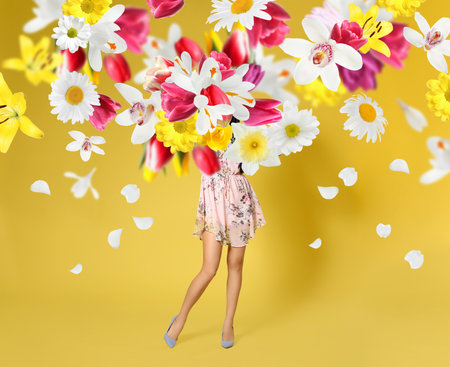 creative spring fashion composition. Posing girl and flowers splashの写真素材