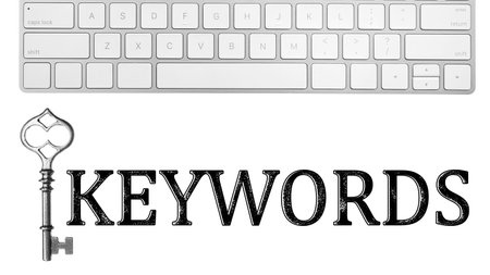 Word Keywords, computer keyboard and key on white background. SEO direction