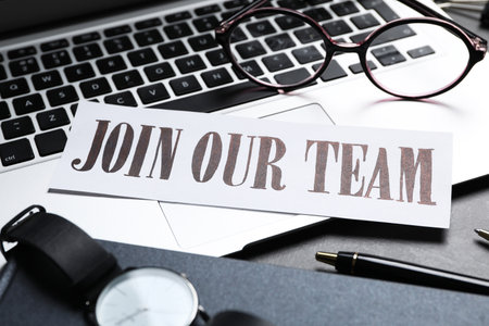 Card with words JOIN OUR TEAM and laptop on table, closeup. Career conceptの写真素材