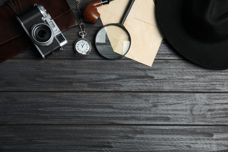 Flat lay composition with vintage detective items on grey wooden background, space for textの写真素材