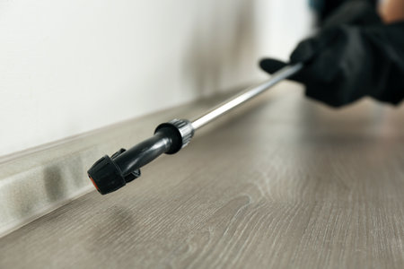 Pest control worker spraying pesticide indoors, closeupの写真素材