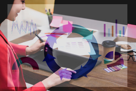 Female designer working at desk and illustration of colorful graphs. double exposure