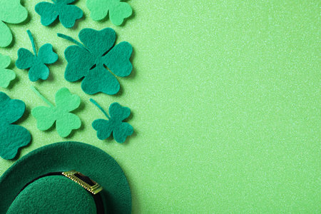 Flat lay composition with clover leaves on light green background, space for text. St. Patrick's Day celebrationの写真素材