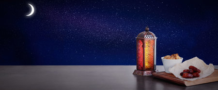 Traditional Ramadan lantern and dry fruits on table, banner design. Muslim holidaysの写真素材