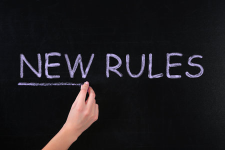 Woman writing text NEW RULES on chalkboard, closeupの写真素材