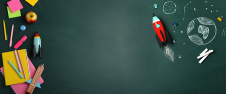 Bright toy rocket, school supplies and drawings on chalkboard, flat lay with space for text. banner designの写真素材