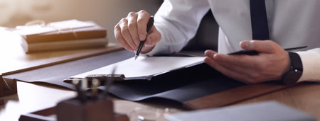 Male lawyer working at table in office, closeup. banner design