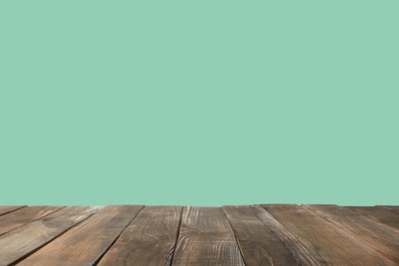 Empty wooden surface on mint background. Mockup for design
