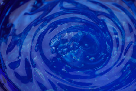 Pure transparent cosmetic gel on blue background, closeupの写真素材