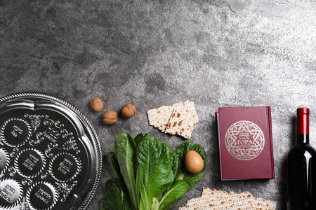Flat lay composition with Passover Seder plate (keara) on gray table, space for text. Pesah...