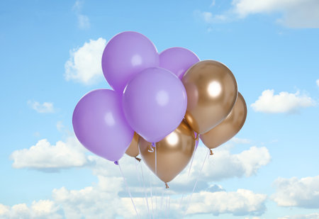 Bunch of colorful balloons outdoors on sunny dayの写真素材