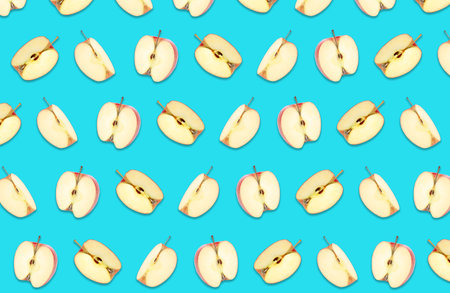 Pattern of cut apples on blue backgroundの写真素材