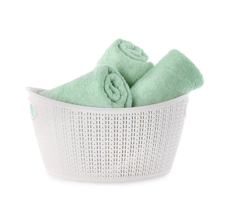 Fresh rolled towels in plastic bowl isolated on whiteの写真素材
